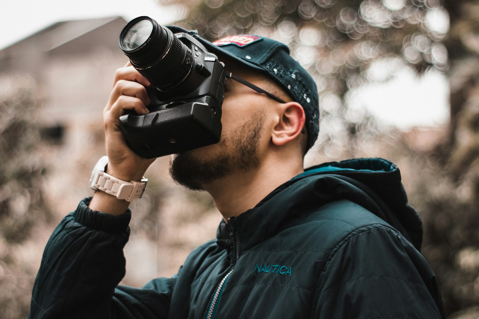 Photographer taking a picture with a DSLR camera outdoors